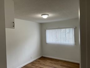 Cudahy apartment for rent - A room with a window covered by white blinds.