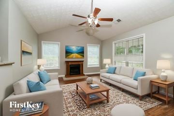 Covington house for rent - A living room with a couch, a coffee table, and a painting on the wall.