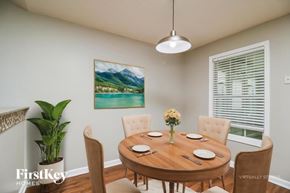 Covington house for rent - A dining room with a wooden table set for six.
