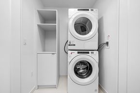 Toronto apartment for rent - A white washing machine and dryer in a small laundry room.