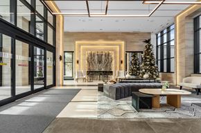 Toronto apartment for rent - A modern living room with a Christmas tree and a fireplace.