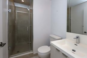 Toronto apartment for rent - A white toilet sits next to a sink in a bathroom.
