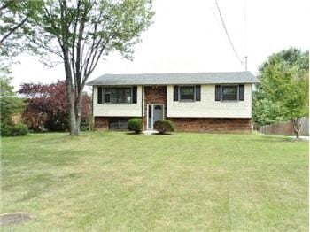 Burlington house for rent - A house with a white door and windows sits in a grassy yard.