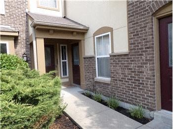 Covington house for rent - A brick house with a red door and a window.
