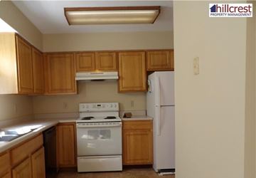 Florence house for rent - A kitchen with wooden cabinets and white appliances.