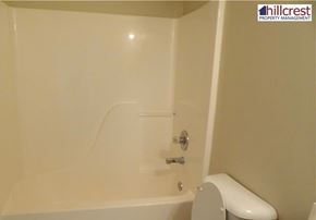 Florence house for rent - A white toilet sits next to a bathtub in a bathroom.