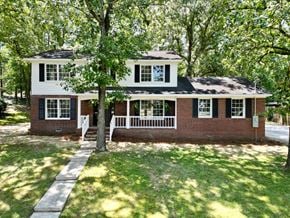 Rome house for rent - A white house with a black roof and a brick chimney.