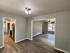 Rome house for rent - A spacious room with wood flooring and a large window.