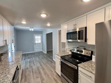 Rome house for rent - A kitchen with a stove top oven and microwave.