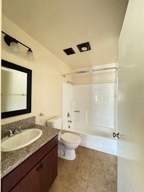 Van Nuys apartment for rent - A bathroom with a toilet, sink, and shower.