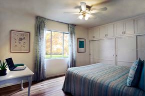 Los Angeles apartment for rent - A bedroom with a bed, desk, and window.