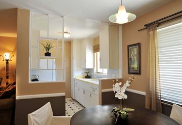 Los Angeles apartment for rent - A dining room with a table set for two and a kitchen area in the background.