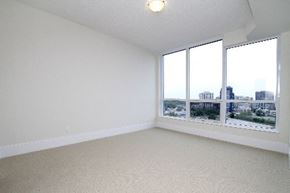 Toronto apartment for rent - A room with a window overlooking a cityscape.