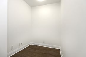 Toronto apartment for rent - A room with white walls and a wooden floor.