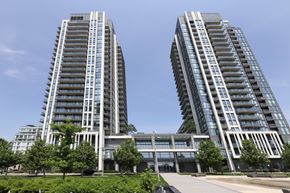 Toronto apartment for rent - Two tall buildings with balconies on the side are surrounded by greenery.