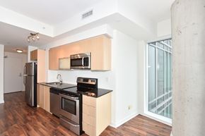 Toronto apartment for rent - A kitchen with wooden cabinets and stainless steel appliances.