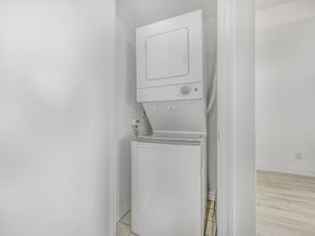 Toronto apartment for rent - A white dryer is sitting in a small, white-walled room.