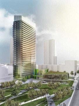 Toronto apartment for rent - A modern skyscraper with a green roof is surrounded by a park and a road.