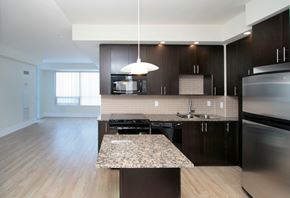 North York apartment for rent - A modern kitchen with dark wood cabinets and stainless steel appliances.