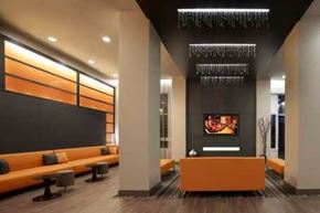 North York apartment for rent - A modern office lobby with a reception desk and orange seating.