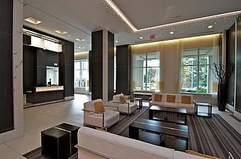 North York apartment for rent - A spacious living room with a white couch and a coffee table.