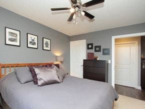 Etobicoke apartment for rent - A bedroom with a bed, dresser, and pictures on the wall.