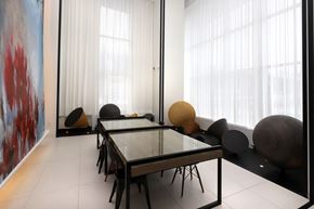 Toronto apartment for rent - A modern dining room with a glass table and chairs.