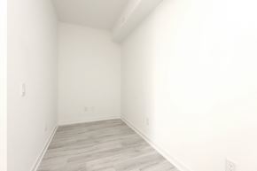 Mississauga apartment for rent - A room with white walls and wooden flooring.