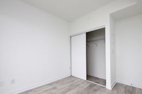 Mississauga apartment for rent - A room with a white door and a wooden floor.