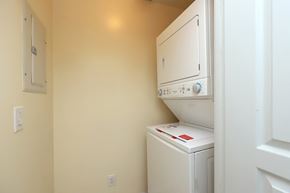 Mississauga apartment for rent - A white dryer is in a small room with a white wall.