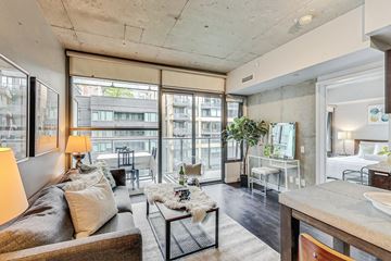 Toronto apartment for rent - A living room with a brown couch and a coffee table.