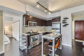 Toronto apartment for rent - A kitchen with a table and chairs in the middle of it.