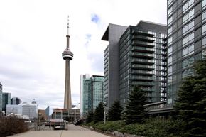Toronto apartment for rent - A tall building with a pointed top stands in front of a modern glass building.