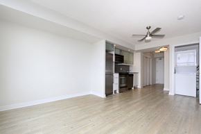 Toronto apartment for rent - A spacious kitchen with a refrigerator, oven, and microwave.