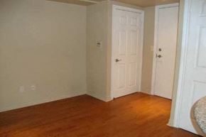 Toronto apartment for rent - A room with two white doors and a wooden floor.