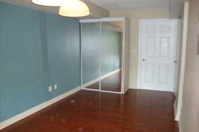 Toronto apartment for rent - A room with a white door and a glass door.