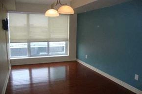Toronto apartment for rent - A room with a window covered by white blinds and a light hanging from the ceiling.