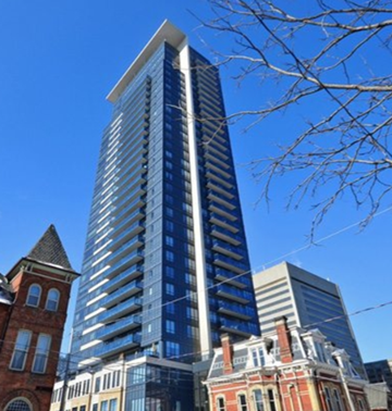 Toronto apartment for rent - A tall blue and white building stands next to a shorter red brick building.