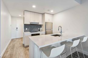 Park City apartment for rent - A kitchen with a white counter and white chairs.
