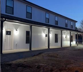 Mccomb apartment for rent - A building with lights on the front at night.