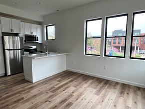 Baltimore apartment for rent - A kitchen with a refrigerator, microwave, and sink.
