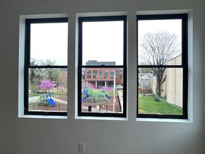 Baltimore apartment for rent - Three windows with different views of a playground, a building, and a tree.