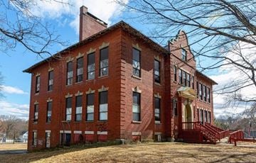 Maynard apartment for rent - A red brick building with a bell tower and a steeple.