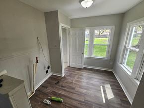 Lima house for rent - A room with a wooden floor and a white door.
