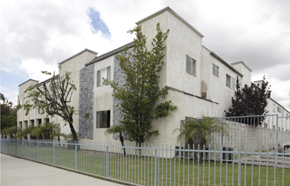 Sun Valley apartment for rent - A white building with a grey fence in front.