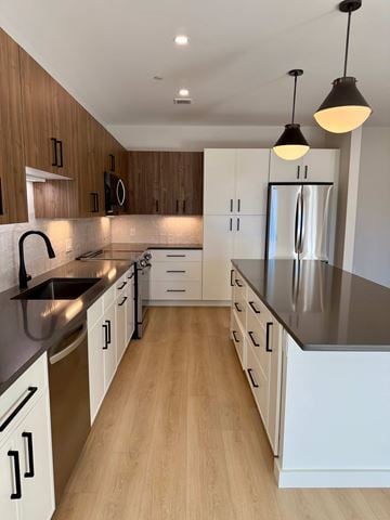 Bedford apartment for rent - A modern kitchen with wooden cabinets and a stainless steel refrigerator.