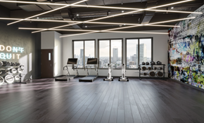 Bayonne apartment for rent - A gym with a large window overlooking a city skyline.