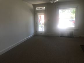 West Lawn house for rent - A room with a carpeted floor and a window letting in sunlight.