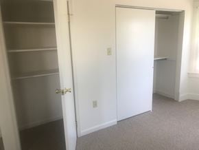 West Lawn house for rent - A white door is in a room with a carpeted floor.