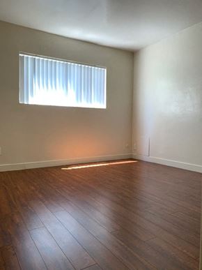 North Hollywood apartment for rent - A room with a window and wooden flooring.